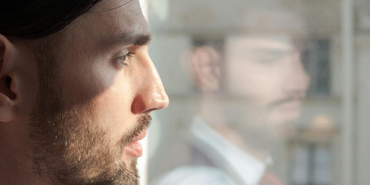 A person looking thoughtfully, symbolizing uncertainty about career progression or business challenges.